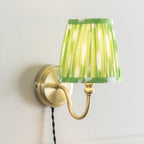 Neely Antique Brass Curved Plug In Wall Light with Green Pleated Shade