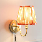 Neely Antique Brass Curved Plug In Wall Light with orange Pleated Shade