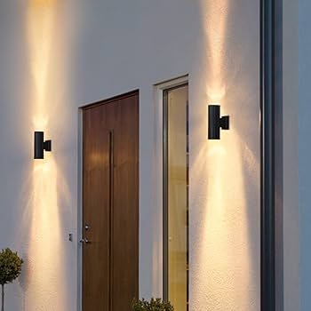 Modern outdoor wall lights on a building exterior with a door and window.