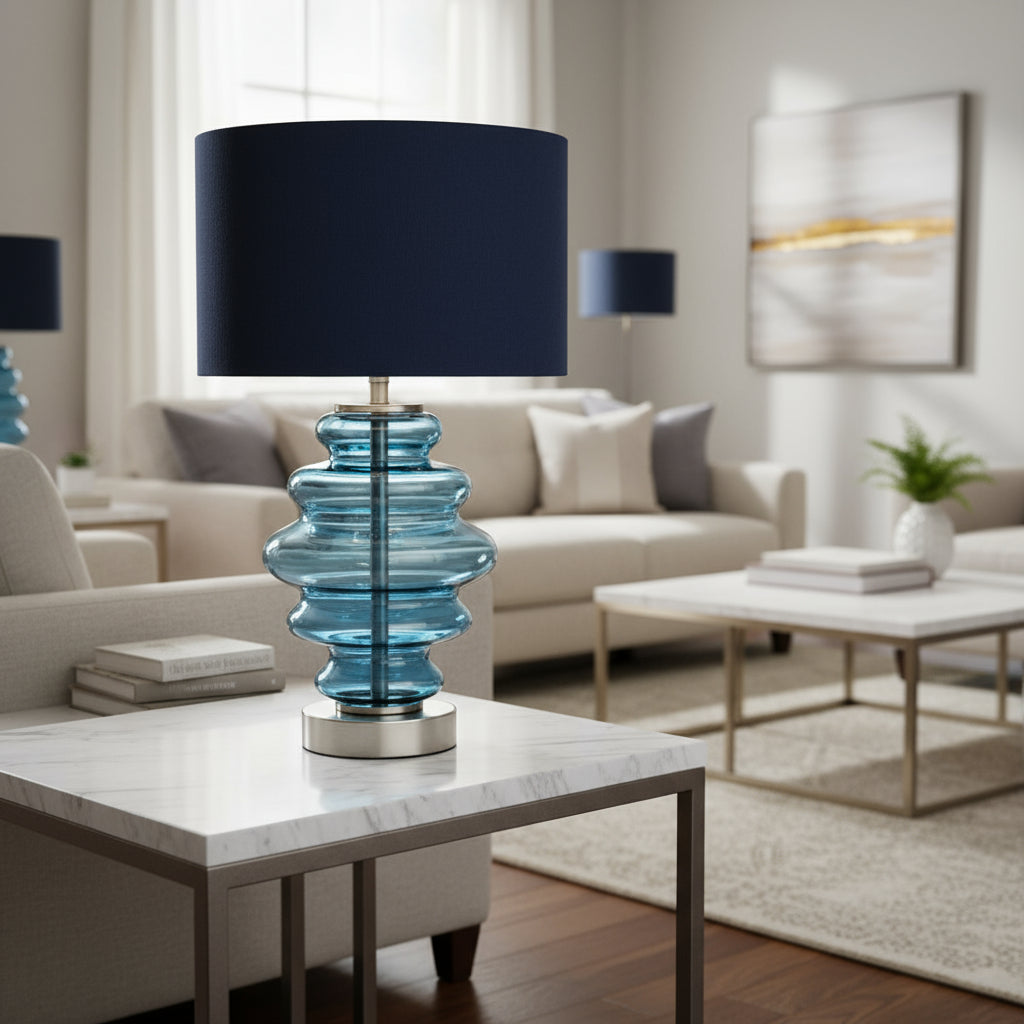 Table lamp with blue glass base and black shade on a white background